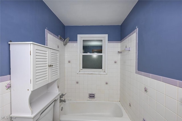 full bathroom with shower / washtub combination and tile walls