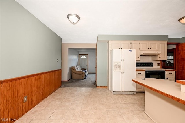 kitchen featuring white refrigerator with ice dispenser, light countertops, wainscoting, range with electric cooktop, and under cabinet range hood