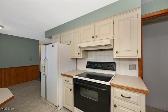 kitchen with white refrigerator with ice dispenser, wainscoting, black electric range oven, light countertops, and under cabinet range hood