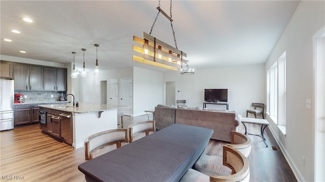 dining room with visible vents, recessed lighting, light wood-style flooring, and baseboards