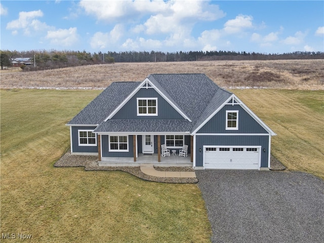 view of front of property featuring driveway, a garage, a porch, roof with shingles, and a front lawn