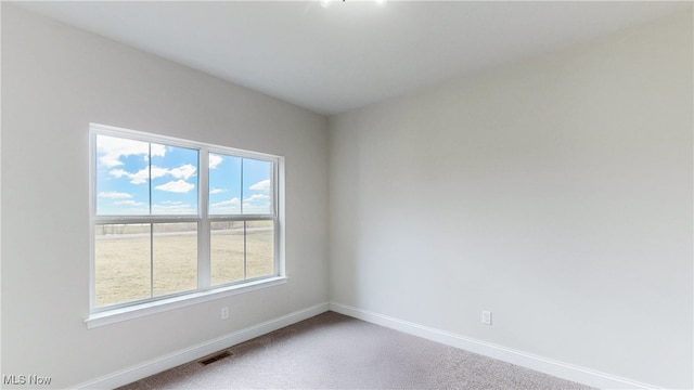 carpeted empty room with baseboards and visible vents