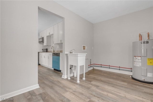 interior space with water heater and a sink