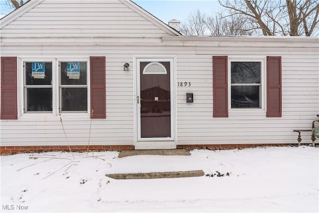 view of snow covered property entrance