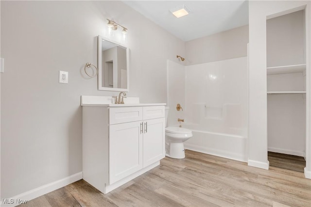1893 Benjamin Rd, Madison, OH 44057 - bathroom featuring wood finished floors, bathing tub / shower combination, vanity, toilet, and baseboards