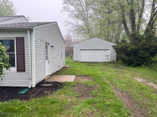 1893 Benjamin Rd, Madison, OH 44057 - view of green lawn with an outbuilding and a garage