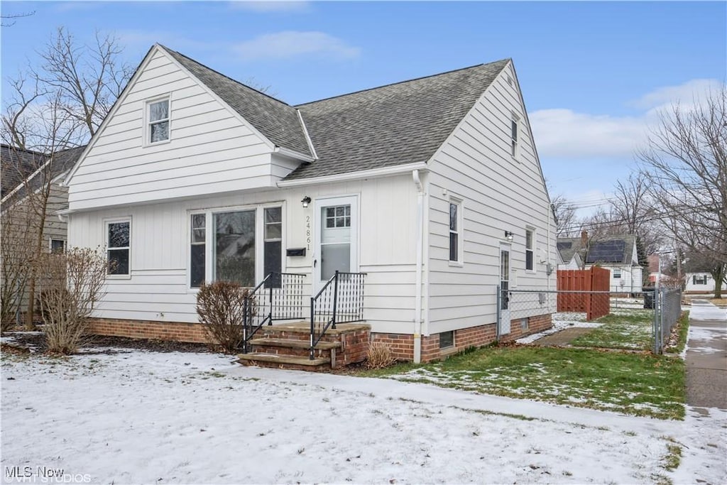 24861 Puritan Rd, Euclid, OH 44123 - view of front facade with crawl space, roof with shingles, and fence