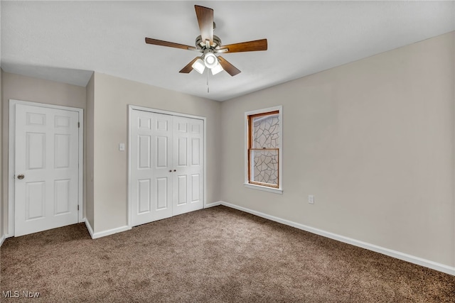 unfurnished bedroom featuring a closet, carpet flooring, a ceiling fan, and baseboards