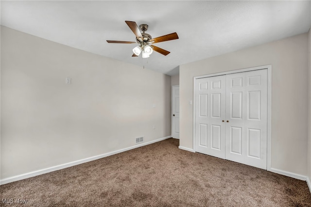 unfurnished bedroom featuring carpet, a closet, visible vents, ceiling fan, and baseboards