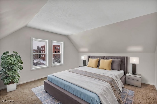 bedroom featuring carpet flooring, vaulted ceiling, and baseboards