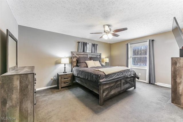 bedroom featuring a textured ceiling, dark carpet, a ceiling fan, and baseboards