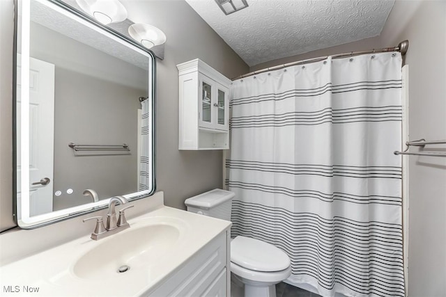 full bathroom with visible vents, toilet, a shower with curtain, a textured ceiling, and vanity