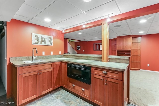 kitchen with oven, a sink, a peninsula, and open shelves