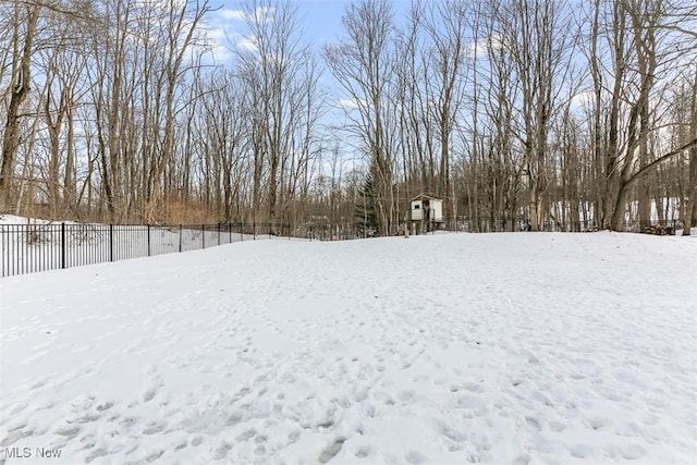 yard covered in snow with fence