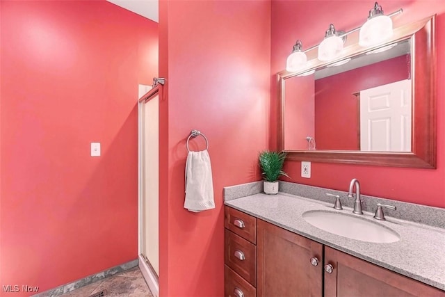 full bath with a shower stall and vanity