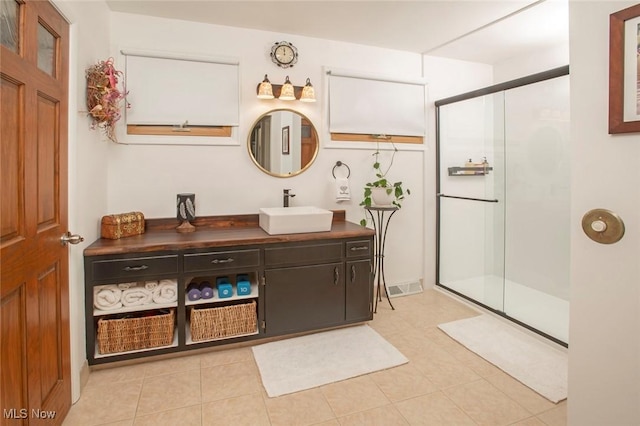 full bath with visible vents, tile patterned flooring, an enclosed shower, and vanity