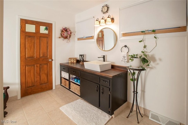 bathroom with vanity, visible vents, and tile patterned floors