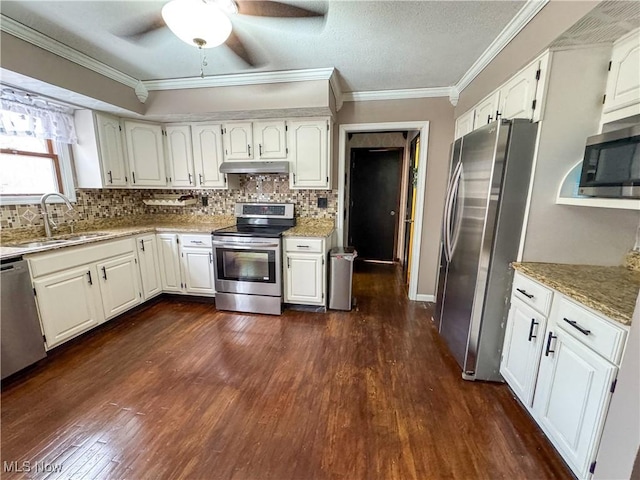 kitchen with dark wood-style floors, crown molding, stainless steel appliances, a sink, and under cabinet range hood