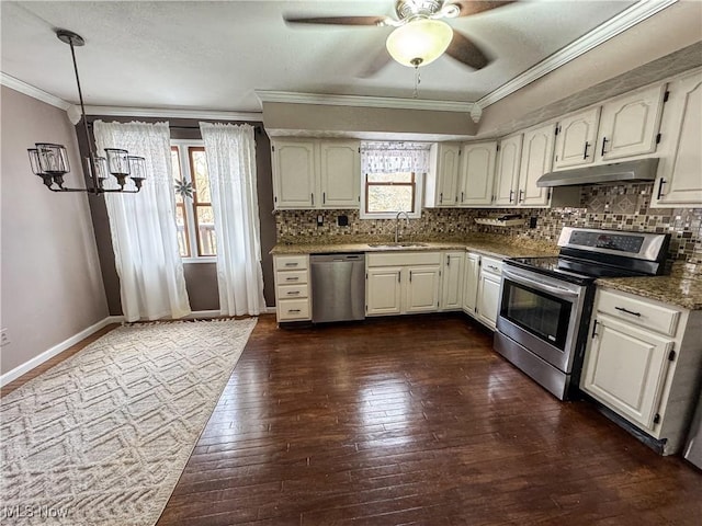 kitchen with plenty of natural light, appliances with stainless steel finishes, crown molding, under cabinet range hood, and a sink