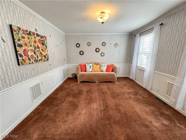 sitting room featuring carpet floors, wallpapered walls, visible vents, and wainscoting