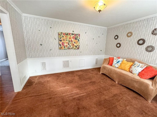 living area with carpet floors, visible vents, wainscoting, wallpapered walls, and crown molding