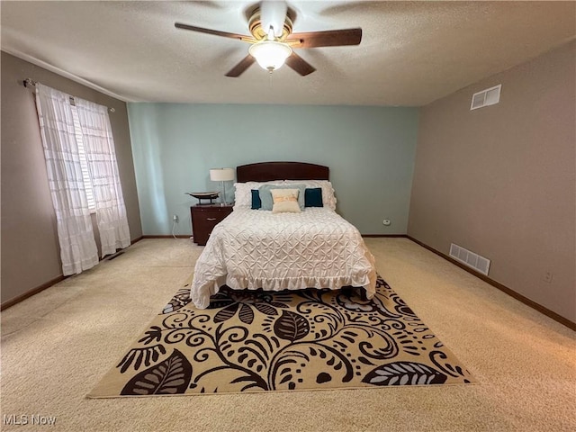 bedroom featuring visible vents, a textured ceiling, and baseboards