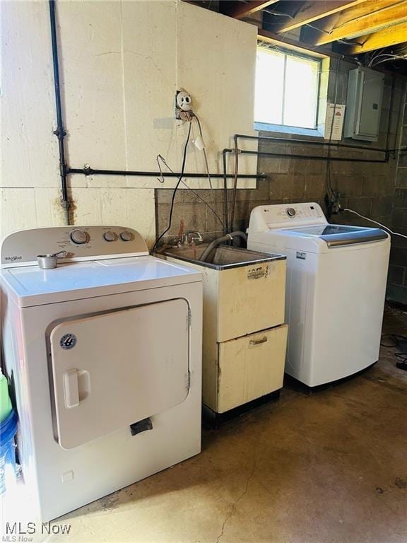 laundry area featuring laundry area, electric panel, and washer and clothes dryer