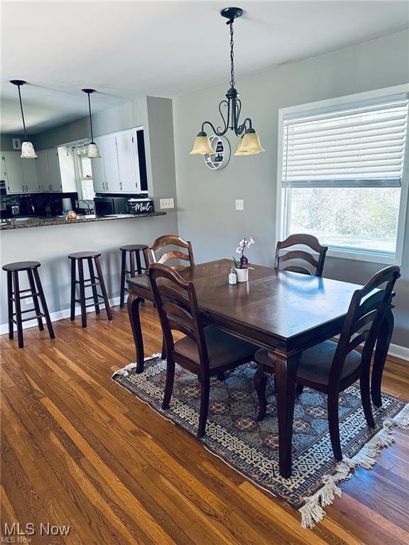 dining room with dark wood-style floors and baseboards