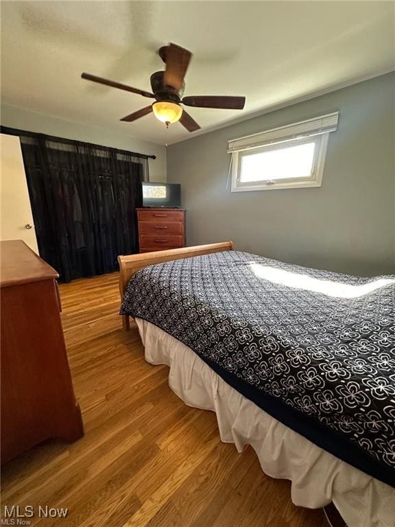 bedroom featuring ceiling fan and wood finished floors