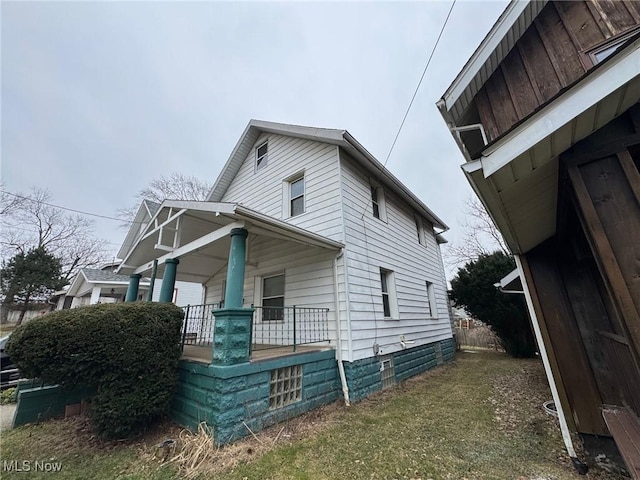 view of side of property featuring a porch