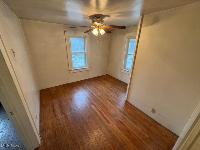 unfurnished room with plenty of natural light, a ceiling fan, and hardwood / wood-style floors