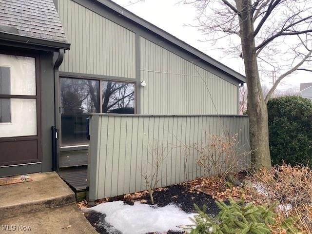 view of side of property featuring a shingled roof