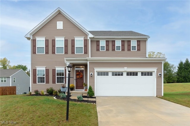 view of front of house featuring a front yard, concrete driveway, and an attached garage