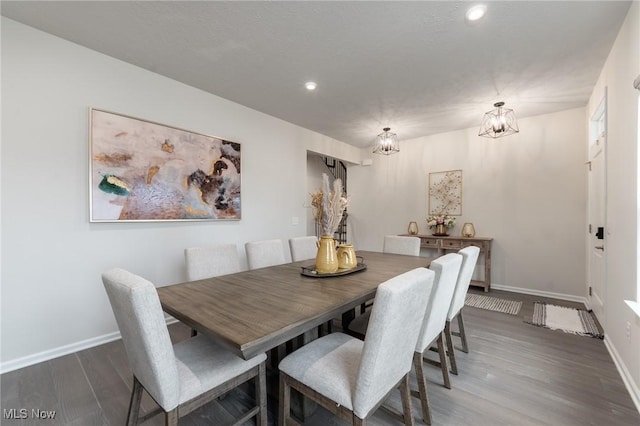 dining area featuring a notable chandelier, dark wood-type flooring, recessed lighting, and baseboards