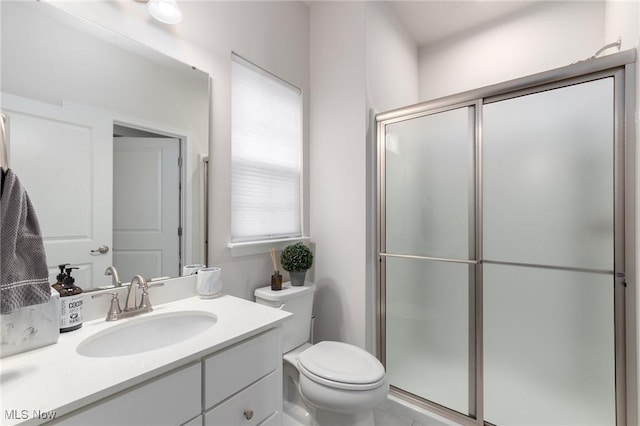 full bathroom with toilet, an enclosed shower, and vanity