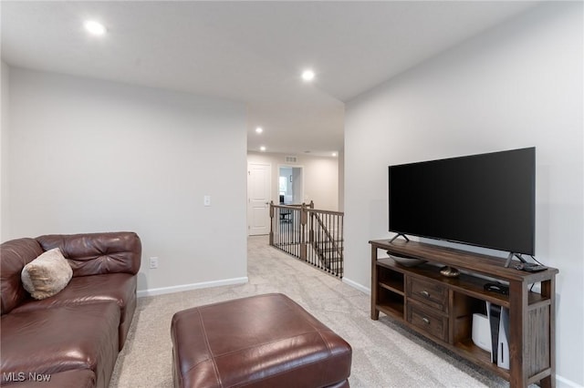 living area with recessed lighting, light colored carpet, and baseboards