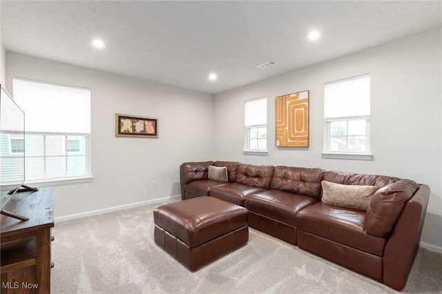 carpeted living room featuring visible vents, baseboards, and recessed lighting