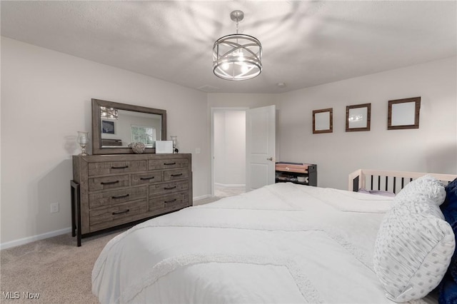 bedroom with baseboards and light colored carpet