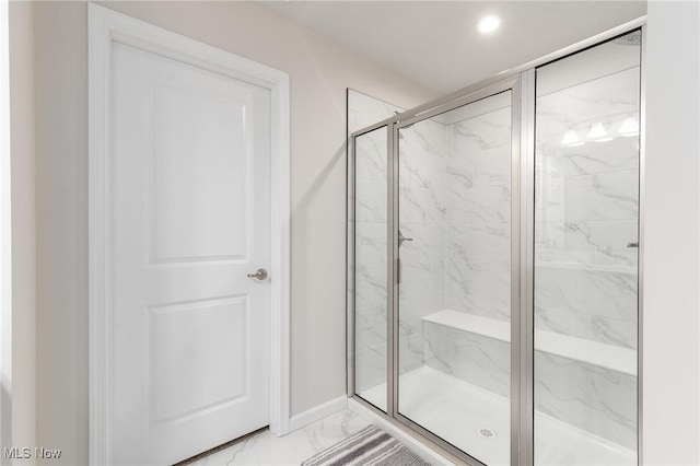 bathroom featuring marble finish floor, recessed lighting, a marble finish shower, and baseboards