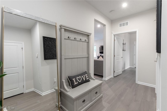 mudroom with light wood-style flooring, visible vents, and baseboards