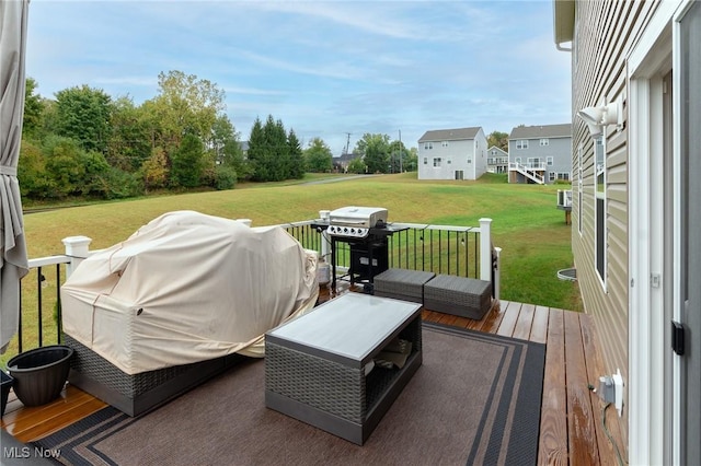 wooden terrace with a yard and outdoor lounge area