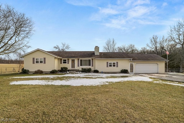 ranch-style home with a chimney, an attached garage, fence, driveway, and a front lawn