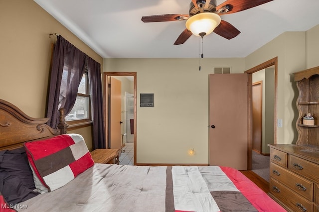 bedroom featuring a ceiling fan, visible vents, and ensuite bath