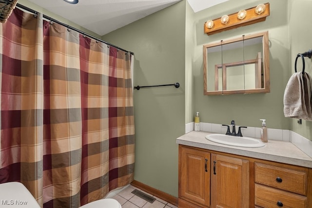 bathroom featuring tile patterned flooring, toilet, a shower with shower curtain, vanity, and visible vents