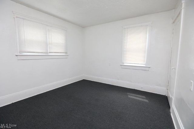 spare room with carpet floors and baseboards