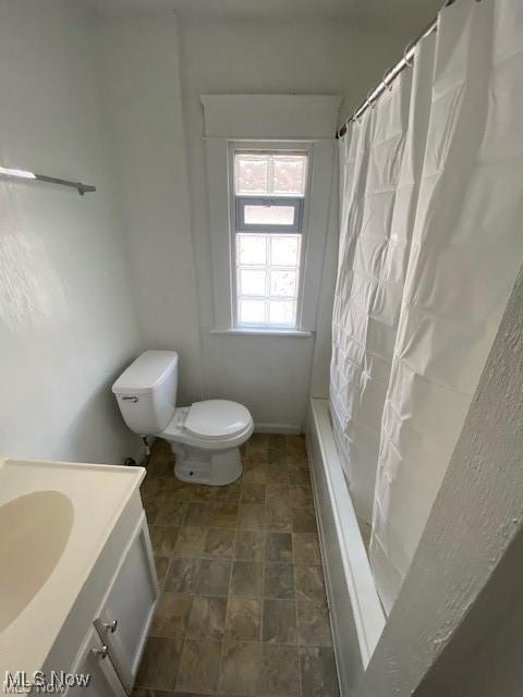 full bathroom featuring vanity, toilet, and shower / bath combo with shower curtain