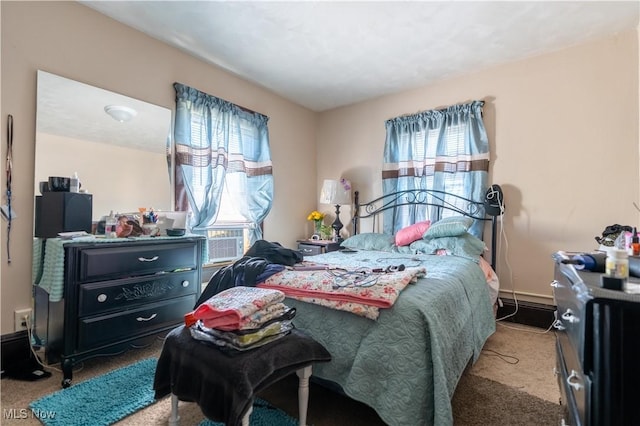 bedroom with baseboards, cooling unit, and light colored carpet