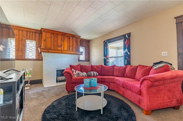 living area featuring a fireplace and carpet flooring