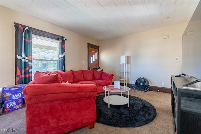 carpeted living area featuring baseboards