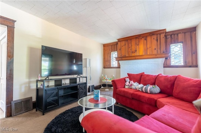 carpeted living area featuring baseboards and visible vents